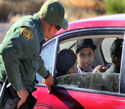 SASABE, AZ - JUNE 01: A Border Patrol agent checks vehicles for illegal immigrants and contraband at a roadside checkpoint June 1, 2010 near Sasabe, Arizona. During the 2009 fiscal year 540,865 undocumented immigrants were apprehended entering the United States illegally along the Mexican border, 241,000 of those were captured in the 262 mile stretch of the border known as the Tucson Sector. (Photo by Scott Olson/Getty Images)