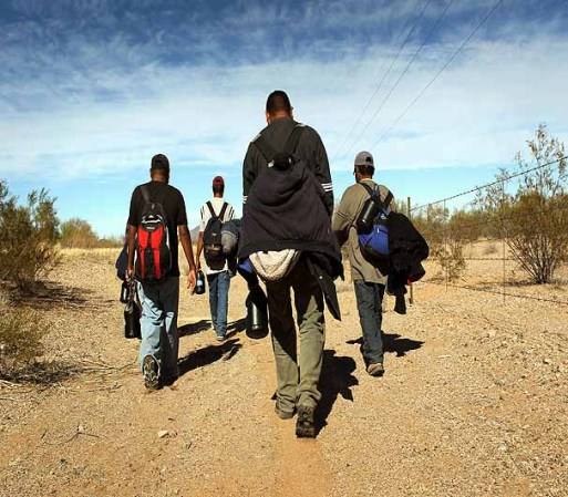 TOHONO O'ODHAM NATION, AZ - JANUARY 19: Undocumented Mexican immigrants walk through the Sonoran Desert after illegally crossing the U.S.-Mexico border border on January 19, 2011 into the Tohono O'odham Nation, Arizona. The immigrants said they had wandered the desert lost for a week after crossing from Mexico into the vast Indian reservation at night. Exhausted, they requested the Border Patrol to pick them up and take them to the U.S.-Mexico border, from where they would return to their homes in the Mexican state of Sonora. They had come, they said, to reach Phoenix and find work in construction or landscaping. All said they had worked in Arizona before. (Photo by John Moore/Getty Images)