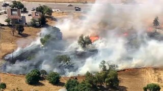 A brush fire burns near downtown San Jose and Mineta San Jose International Airport.