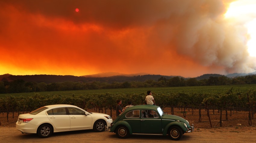 People watch a fire.
