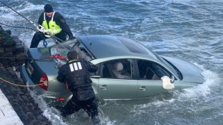 Crews pull a car out of the San Francisco Bay.