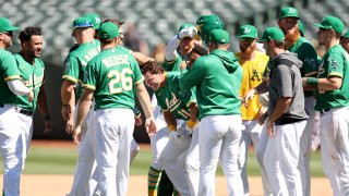 Skye Bolt #11 of the Oakland Athletics is congratulated by teammates.