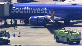 A Southwest Airlines plane parked at a gate at Oakland International Airport.