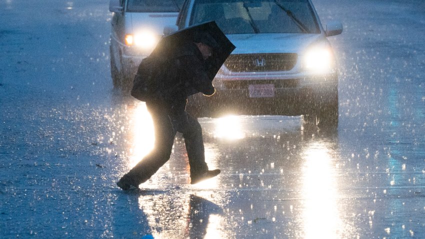 SAN FRANCISCO, CALIFORNIA – JANUARY 04: A pedestrian walks on the street against heavy rain as a bomb cyclone hits California, bringing powerful winds and torrential rain on January 4, 2023 in San Francisco, California. (Photo by Liu Guanguan/China News Service/VCG via Getty Images)