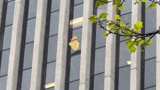 Broken window on 20th flood of building at 50 California St. in San Francisco.