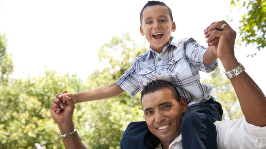 Hispanic Father and Son Having Fun Together in the Park.