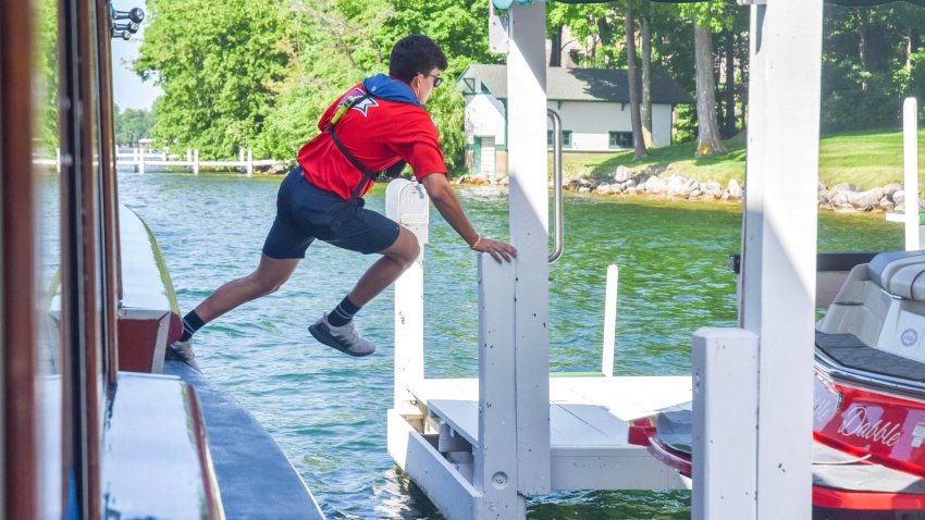 ‘The coolest summer job’: These teens jump off a moving boat to deliver mail in Wisconsin