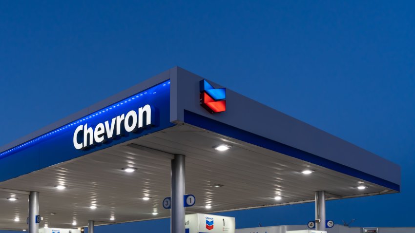 Dallas, Texas, USA – March 19, 2022: Night view of Chevron gas station sign. Chevron Corporation is an American multinational energy corporation.