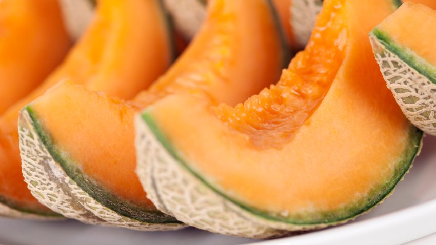 Portions of Cantaloupe on plate. Isolated on white background.