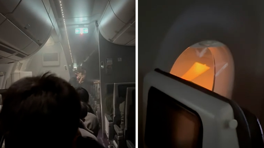 Flight attendant covers her nose and mouth next to picture of flames visible through window