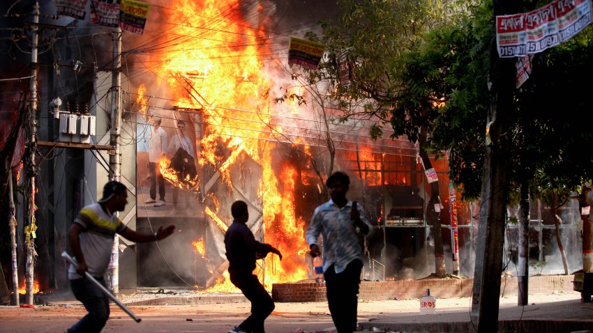 TOPSHOT – A garment store is reportedly set ablaze by a group of unidentified miscreants in Dhaka on August 4, 2024. (Photo by Abu SUFIAN JEWEL / AFP) (Photo by ABU SUFIAN JEWEL/AFP via Getty Images)