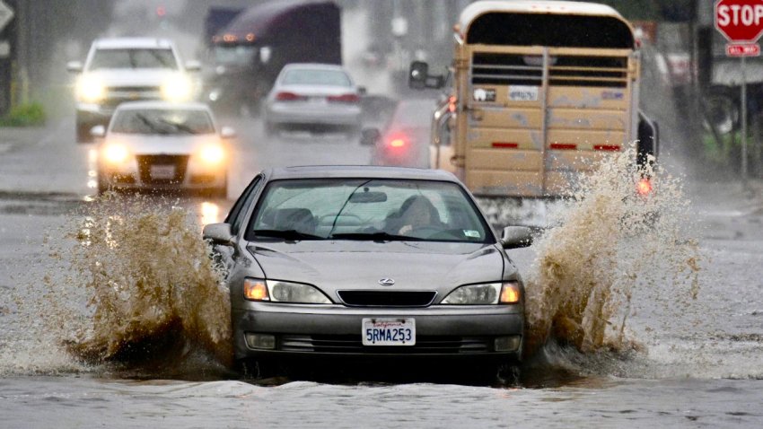 A car maneuvers carefully through the flooded Edison Ave. during a rainstorm in Ontario on Tuesday, Feb. 6, 2024.