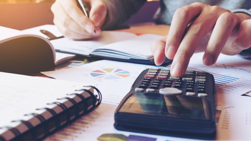 Hand man doing finances and calculate on desk about cost at home office.