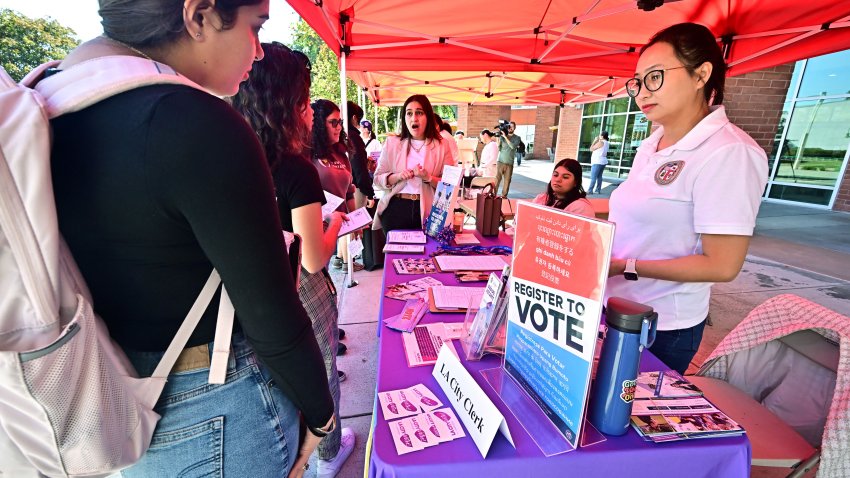 Potential young voters get information at a voter registration desk at Voter Fest 2024, an event designed to engage young voters and historically underserved communities on October 22, 2024 at Cal State Los Angeles in Los Angeles, California, ahead of the 2024 US presidential elections on November 5. (Photo by Frederic J. BROWN / AFP) (Photo by FREDERIC J. BROWN/AFP via Getty Images)