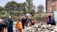 People gather in an open area following earthquake tremors in Kathmandu, in the early hours on January 7, 2025. A powerful earthquake in China’s remote Tibet region killed at least 32 people and collapsed “many buildings” on January 7, Chinese media reported, with tremors also felt in neighbouring Nepal’s capital Kathmandu and parts of India. (Photo by SUNIL SHARMA / AFP) (Photo by SUNIL SHARMA/AFP via Getty Images)