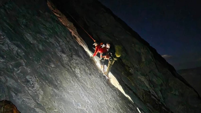 This photo released by Mono County Sheriff Search and Rescue shows a rescuer with the man who was stranded, Rob Martin.
