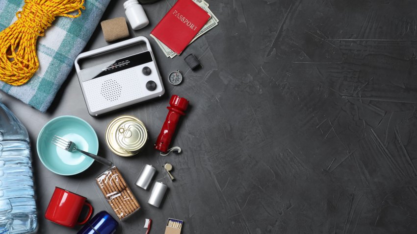 Earthquake supply kit on dark grey table, flat lay. Space for text